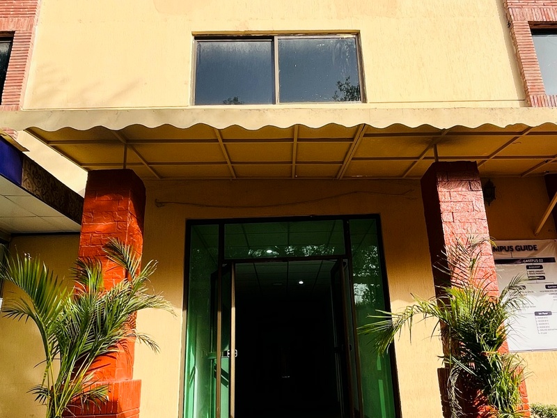 Crescent College campus entrance with plants and doorway