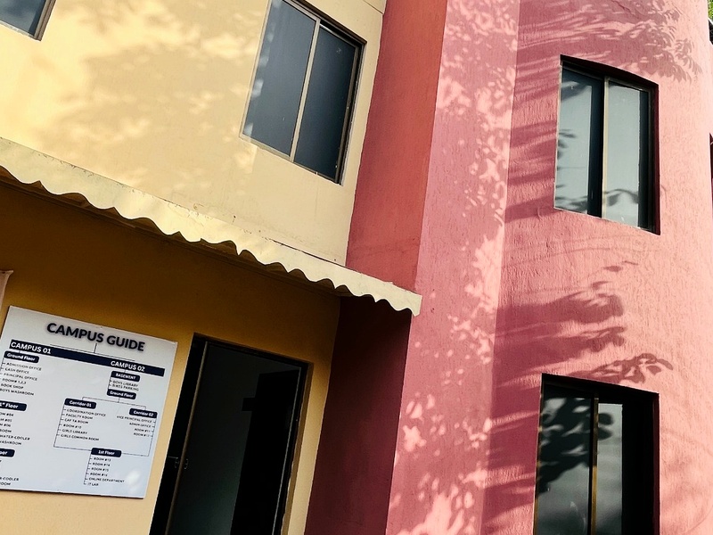 Crescent College academic block exterior and campus guide board